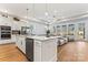 Modern kitchen with island, stainless steel appliances, and white cabinets at 1025 Lake Como Dr, Monroe, NC 28110