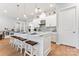 Modern kitchen with white cabinets, large island, and stainless steel appliances at 1025 Lake Como Dr, Monroe, NC 28110