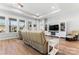 Spacious living room featuring a large sectional sofa, built in shelving and hardwood floors at 1025 Lake Como Dr, Monroe, NC 28110