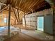 Unfinished attic featuring open rafters, insulation, and a doorway for future customization at 1037 Oakmont Dr, Rock Hill, SC 29732