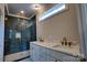 Modern bathroom featuring a glass shower with blue tiles, double sink vanity, and a marble countertop at 1037 Oakmont Dr, Rock Hill, SC 29732