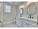 Elegant bathroom featuring double vanity with marble countertop, gold-framed mirrors, and modern fixtures at 1037 Oakmont Dr, Rock Hill, SC 29732