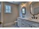 Bright bathroom featuring double vanity with elegant fixtures and a framed mirror at 1037 Oakmont Dr, Rock Hill, SC 29732