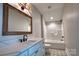 Bright bathroom featuring marble countertop, patterned floors, bathtub and shower combo at 1037 Oakmont Dr, Rock Hill, SC 29732