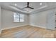 Large, bright bedroom with a tray ceiling, fan, LVP flooring, and a large window at 1037 Oakmont Dr, Rock Hill, SC 29732