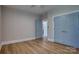 Spacious bedroom with wood-look flooring and two blue painted doors at 1037 Oakmont Dr, Rock Hill, SC 29732