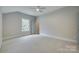 Bedroom with neutral carpet, ample natural light, and an en-suite bathroom at 1037 Oakmont Dr, Rock Hill, SC 29732