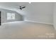 Bright bonus room with neutral carpet, ceiling fan and natural light streaming in at 1037 Oakmont Dr, Rock Hill, SC 29732