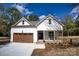 Charming two-story home with a welcoming front porch, lovely landscaping, and a two-car garage at 1037 Oakmont Dr, Rock Hill, SC 29732