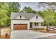 Charming home boasts a wood-toned garage door and welcoming front porch at 1037 Oakmont Dr, Rock Hill, SC 29732