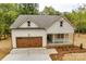 Craftsman-style home with a wood-toned garage door and inviting front porch at 1037 Oakmont Dr, Rock Hill, SC 29732