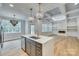 Open kitchen with a marble island, stainless steel appliances, and pendant lighting adjacent to the living room at 1037 Oakmont Dr, Rock Hill, SC 29732