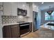 Modern kitchen featuring stainless appliances, white cabinets, stylish backsplash, and a center island at 1037 Oakmont Dr, Rock Hill, SC 29732