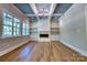 Bright living room featuring hardwood floors, built-in shelving, a fireplace, and large windows at 1037 Oakmont Dr, Rock Hill, SC 29732