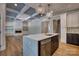 Open concept living room and kitchen with light-colored walls, hardwood floors, and modern lighting at 1037 Oakmont Dr, Rock Hill, SC 29732