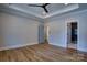 Main bedroom boasting a tray ceiling, wood-look flooring, and ensuite bathroom at 1037 Oakmont Dr, Rock Hill, SC 29732