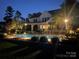 House exterior, pool and backyard at night with lighting at 116 Cedar Branch Ct, Mooresville, NC 28117