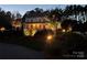 Two-story home with front porch and beautiful landscape lighting at night at 116 Cedar Branch Ct, Mooresville, NC 28117