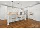 Spacious kitchen featuring a large island, stainless steel appliances, and white cabinetry at 116 Cedar Branch Ct, Mooresville, NC 28117