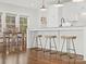 Bright kitchen with an island, hardwood floors, and a view into the dining area at 116 Cedar Branch Ct, Mooresville, NC 28117