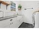 Laundry room with farmhouse sink, white cabinets, and tile flooring at 116 Cedar Branch Ct, Mooresville, NC 28117