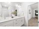 Bright bathroom with double sink vanity, large mirror, and white cabinets and drawers at 1305 39Th Avenue Ne Pl, Hickory, NC 28601