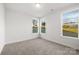 A bright bedroom featuring neutral carpet, three windows, and light walls at 1305 39Th Avenue Ne Pl, Hickory, NC 28601