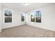 A bright bedroom featuring neutral carpet and three windows at 1305 39Th Avenue Ne Pl, Hickory, NC 28601