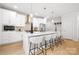 Modern kitchen with a large island, white cabinets, stainless steel appliances, and stylish pendant lighting at 1305 39Th Avenue Ne Pl, Hickory, NC 28601