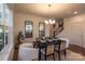 Modern dining room with four chairs and a black table, hardwood floors and large windows at 1305 39Th Avenue Nw Pl, Hickory, NC 28601