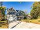 Gray house with blue shutters, a spacious lawn, and a long driveway at 1305 39Th Avenue Nw Pl, Hickory, NC 28601