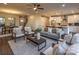 Open living room with gray sofa, white armchairs, hardwood floors and a view into the kitchen at 1305 39Th Avenue Nw Pl, Hickory, NC 28601