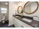 Modern bathroom with double vanity, dark countertop, and stylish mirrors at 187 Lone Pine Rd, Statesville, NC 28625