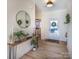 Bright and airy entryway with a large round mirror and console table at 187 Lone Pine Rd, Statesville, NC 28625