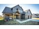 Charming two-story gray home featuring board and batten siding, a welcoming porch, and an attached two-car garage at 187 Lone Pine Rd, Statesville, NC 28625