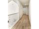 Upstairs hallway with white railings and light wood flooring at 187 Lone Pine Rd, Statesville, NC 28625