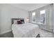 Bright bedroom features natural light, a bed with decorative pillows, and a desk at 2013 Federation Ct, Charlotte, NC 28205