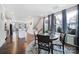 An open-concept dining area with hardwood floors, a round table, natural light, and seamless transition to the kitchen at 2013 Federation Ct, Charlotte, NC 28205