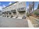 View of the rear of the townhome, showing back garages and private decks at 2013 Federation Ct, Charlotte, NC 28205