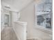 Upstairs hallway with neutral carpet, a white banister, and a large bright window at 2013 Federation Ct, Charlotte, NC 28205