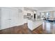 A modern white kitchen features stainless steel appliances, a center island, and hardwood flooring at 2013 Federation Ct, Charlotte, NC 28205