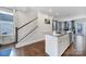 Open-concept kitchen featuring a center island, stainless steel appliances, and hardwood floors with a staircase nearby at 2013 Federation Ct, Charlotte, NC 28205