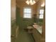 Retro bathroom with green tile, shower/tub combo, and vanity at 211 Walnut Ave, Mount Holly, NC 28120