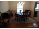 Bright dining room featuring hardwood floors, chandelier, and built-in hutch at 211 Walnut Ave, Mount Holly, NC 28120