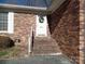 Brick front exterior with a white door and steps at 211 Walnut Ave, Mount Holly, NC 28120