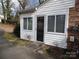 Small white shed with a door and windows at 211 Walnut Ave, Mount Holly, NC 28120