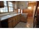 Kitchen with wood cabinets, tile floors, and a window at 211 Walnut Ave, Mount Holly, NC 28120