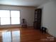 Living room with hardwood floors and large window at 211 Walnut Ave, Mount Holly, NC 28120