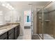 Bathroom with granite countertops, double sinks, and a shower at 2430 Kensington Station Pkwy, Charlotte, NC 28210