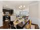 Open concept dining room with kitchen view and hardwood floors at 2430 Kensington Station Pkwy, Charlotte, NC 28210